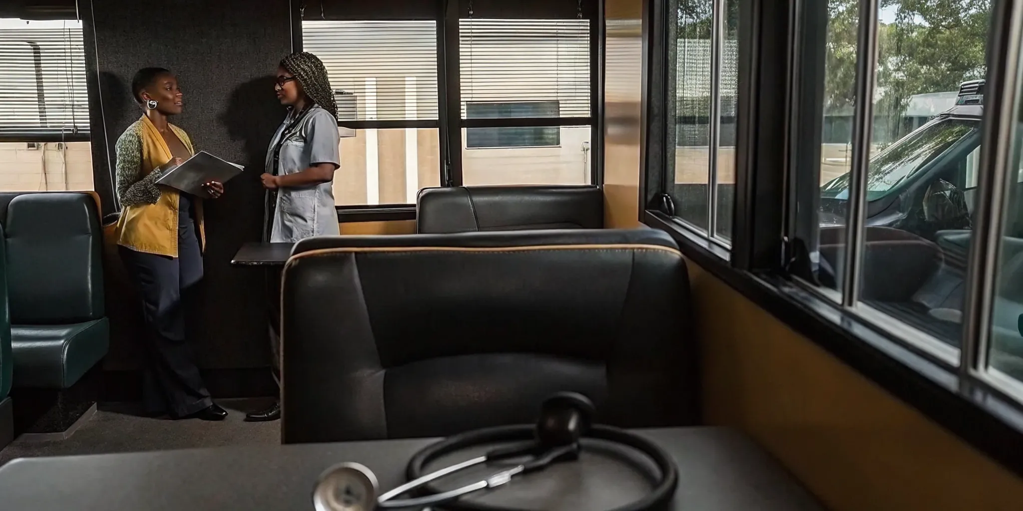 School bus driver consulting with a medical professional about DOT physical certification in a Tampa clinic
